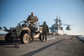 A Polaris MRZR D light tactical vehicle aboard an aircraft carrier.